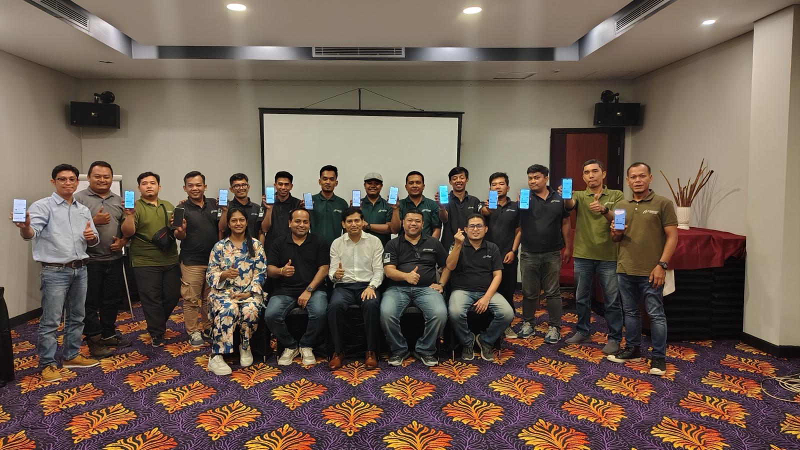 The Albaugh PT Indonesia team at the Farminsta launch, holding up the app on their phones