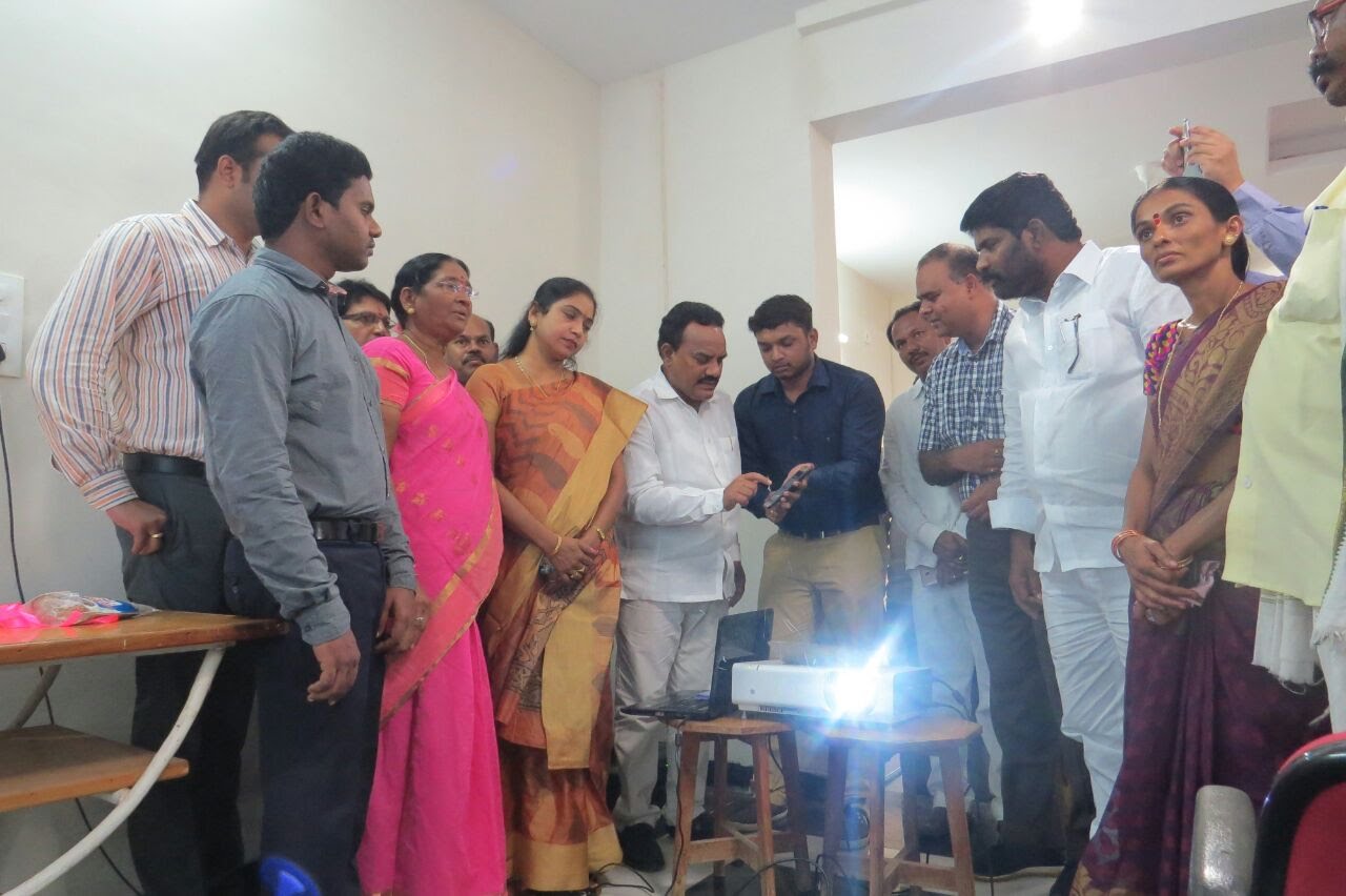 Officials and Anganwadi staff reviewing the Nutri Basket programme app at a demonstration in Andhra Pradesh